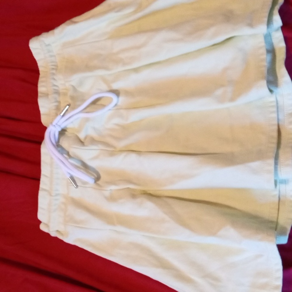 A skirt that is greenish and white bow tie